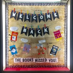 a bulletin board with the words welcome back and books missed you hanging on it's side