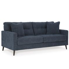 a blue couch with pillows on it