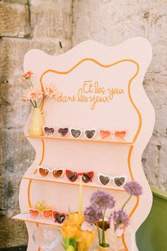 a display case with sunglasses and flowers on it