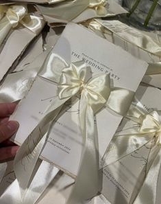 the wedding party's cards are wrapped in satin ribbons