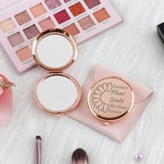 the contents of a makeup set on a white furnishing surface with pink flowers