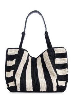 a black and white bag with stripes on the front, sitting against a white background