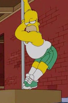 the simpsons standing on top of a box in front of a brick wall and wearing green shorts