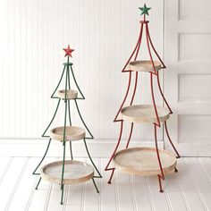 three wooden christmas tree shaped trays sitting next to each other on a white floor