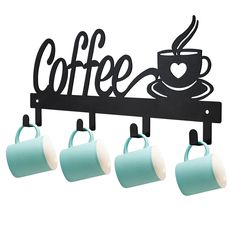 three coffee mugs are hanging on a wall with a sign above them that says coffee