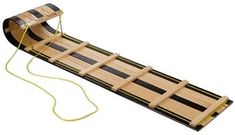 a wooden sled with black and yellow stripes on the bottom, attached to a string