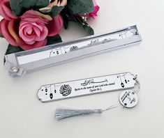 a couple of flowers sitting on top of a table next to a ruler and some scissors