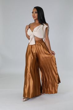 These high-waisted pants are for the fashion-forward woman who wants to make an elegant statement wherever she goes. Featuring a comfortable elastic waistband and pleated detail, these wide-legged beauties will take your wardrobe to the next level. Show off your chic style in these luxurious high-waisted pants. High waisted pants Elastic waistband Pleated Wide leg 30"Inseam No closure 97% Polyester 3% Spandex Hand wash cold Chic Wide Leg Pants With Elastic Waistband, Pleated Wide Leg Pants For Summer, Pleated Wide-leg Pants For Summer, Chic Wide-leg Cargo Pants, Spring Wide Leg Trousers With Pleated Waist, Chic Pleated Summer Pants, Elegant Pleated Summer Bottoms, Elegant Pleated Wide Leg Pants For Summer, Trendy Pleated Wide Leg Pants For Summer