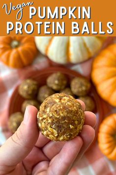 a person holding a pumpkin protein ball in their hand