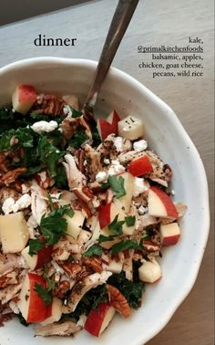 a white bowl filled with food on top of a table