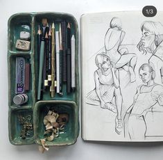 an open sketchbook with pencils, markers and other art supplies