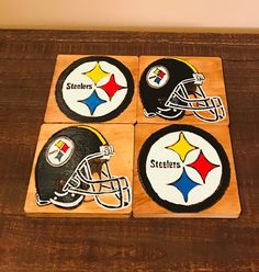 four wooden coasters decorated with football helmets