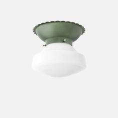 a white ceiling light with a green shade on it's top and bottom half