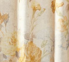 a close up view of a curtain with flowers on the outside and yellow leaves on the inside