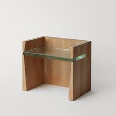 a small wooden table with a green shelf on it's side, against a white background