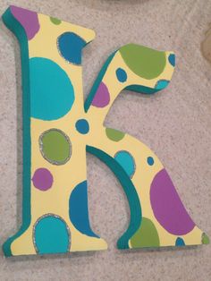 the letter k is decorated with colorful polka dots