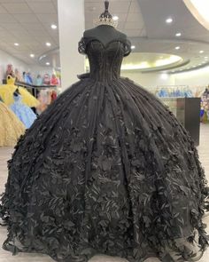 Make a bold and unforgettable statement with the Black Ball Gown Off the Shoulder Quinceanera Dress. This dress is crafted from luxurious tulle fabric and is adorned with intricate appliqued details that add texture and depth. A stunning bow knot at the back gives the dress a playful yet elegant finish, perfect for making a statement at your quinceanera. The off-the-shoulder neckline exudes sophistication, beautifully framing your shoulders and decolletage. The chapel train adds a touch of grand Dresses With Bow, Black Quinceanera Dresses, Ball Gown Prom Dresses, Gown Prom Dresses, Quinceñera Dresses, Black Ball Gown, Pretty Quinceanera Dresses, Dress Ball Gown, Quince Dress