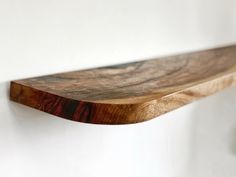 a wooden shelf hanging on the wall