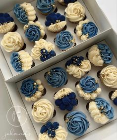 blue and white cupcakes are in a box