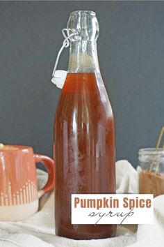 a bottle of pumpkin spice syrup sitting on top of a table