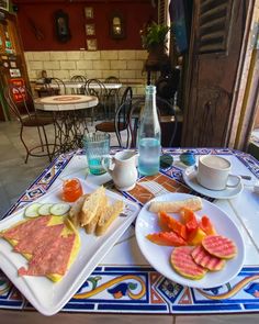 a table topped with plates of food and drinks