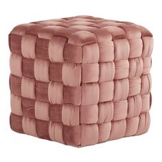 a pink square ottoman that has been made out of fabric and is sitting on a white surface