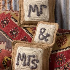 three crocheted pillows sitting on top of a couch with mr and mrs written on them