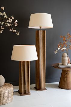 two lamps sitting next to each other on top of a white floor covered in furniture