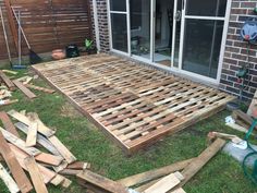 a pile of wood sitting on top of a yard