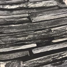 black and white photograph of stacked stone blocks in an old fashioned photo, taken from above