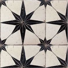 a black and white tile pattern with star shapes