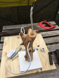 a piece of wood that has been turned into a lamp with wires attached to it