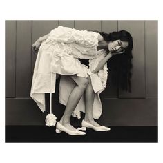 a woman sitting on top of a chair with her arms around another woman's head