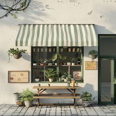 a white building with a green awning and potted plants on the windowsill