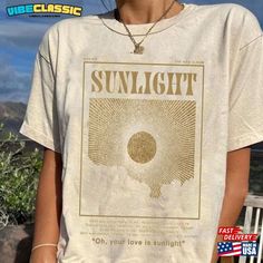 a woman wearing a t - shirt with the words sunlight on it