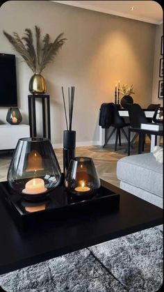 a living room filled with furniture and candles