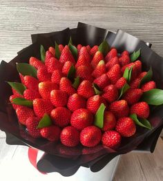 a bunch of strawberries in a black bowl