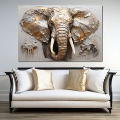 an elephant's head is shown on the wall above a couch