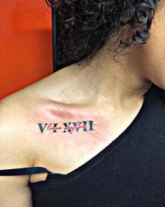 a woman with a small tattoo on her shoulder that says vivvive in cursive writing