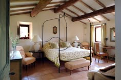 a bed sitting inside of a bedroom on top of a tiled floor next to a window