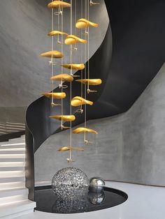 a spiral staircase with yellow objects hanging from it