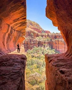 a person standing at the end of a canyon