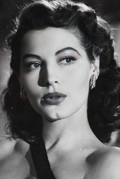 an old black and white photo of a woman in a dress with her eyes closed