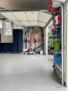 the inside of a garage with various tools and equipment in it, including an overhead storage unit