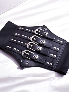 Enhance your edgy and gothic look with this black gothic punk corset belt. Crafted with high-quality materials, this corset belt features a sleek black design with punk-inspired details. Perfect for adding a bold and striking accent to any outfit, this versatile accessory can be paired with a variety of tops and dresses.  Please note that this product includes only the corset belt.  Garment Size   	 		 			Size 			Free Size 		 		 			Width 			12-19 		 		 			Waist 			68-80 Punk Black Corset For Cosplay, Edgy Black Belt Buckle With Removable Belt, Black Punk Corset For Alternative Fashion, Gothic Corset With Belt For Cosplay, Edgy Corset Belt With Belt Loops For Night Out, Edgy Black Belt For Night Out, Black Gothic Corset For Club Wear, Gothic Black Corset For Club, Black Gothic Corset For Club