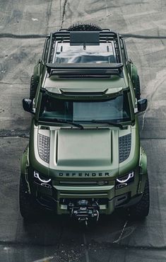 a green truck parked on top of a parking lot