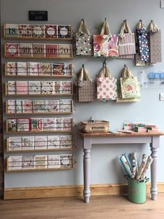 the wall is filled with lots of crafting supplies and crafts on it's shelves