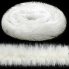 the white fur is laying on top of the black background and next to it's tail