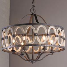 a chandelier hanging from the ceiling with circles and rings on it's sides