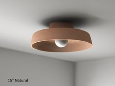 a ceiling light in a room with white walls and flooring, which has the number 15 natural on it